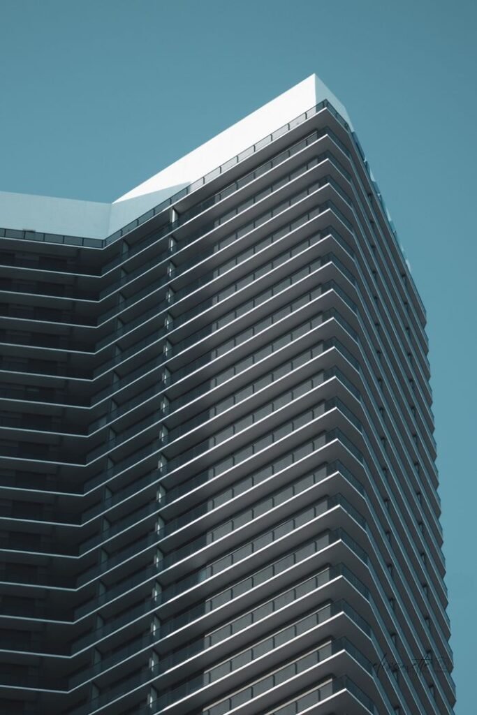 A sleek modern skyscraper against a clear sky, capturing Miami's urban vibe.